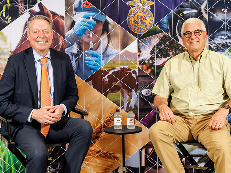 Jayson Lusk and Donnie Smith in front of an agricultural background before the Dean's Dialogue.