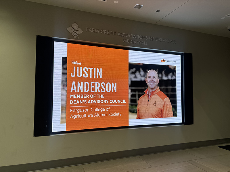 Media wall with "meet Justin Anderson member of the Dean's Advisory Council Ferguson College of Agriculture Alumni Society."