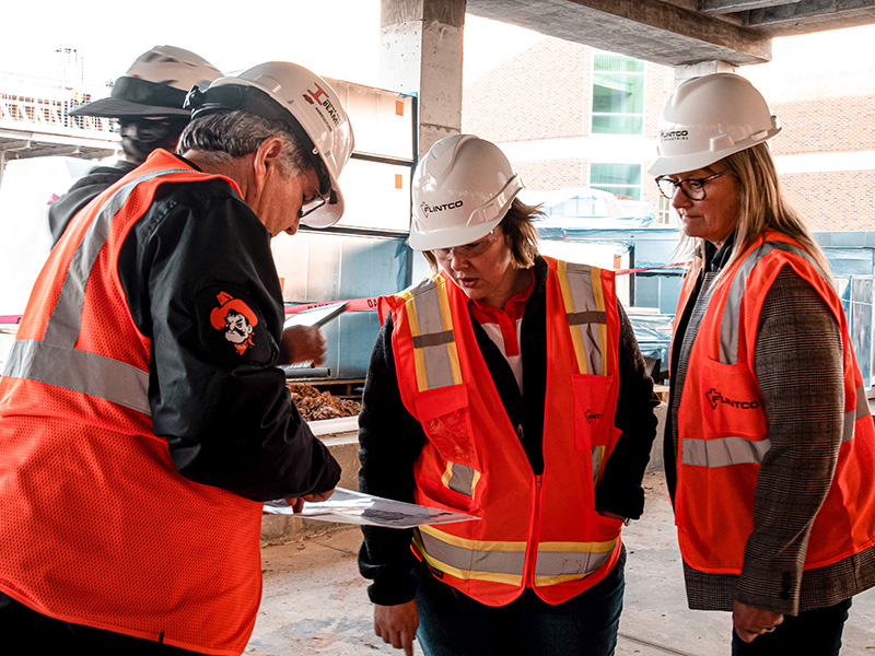 Faculty looking at floor plans