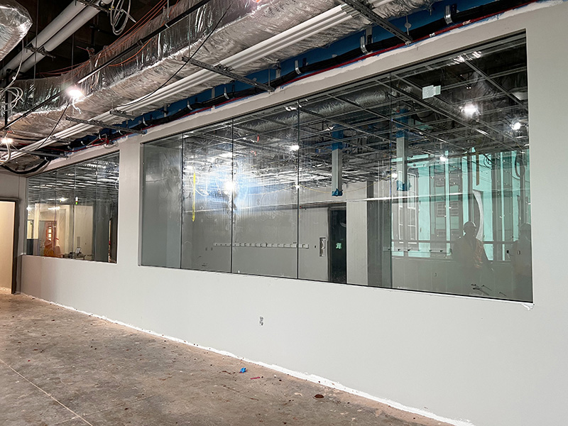 The inside of a building showing a glass wall. 