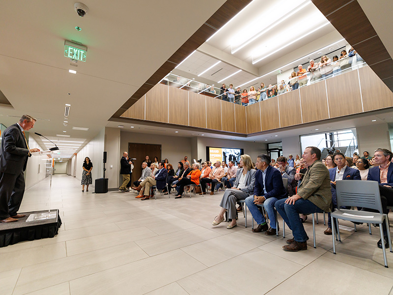 Lusk speaks to a packed house during grand opening