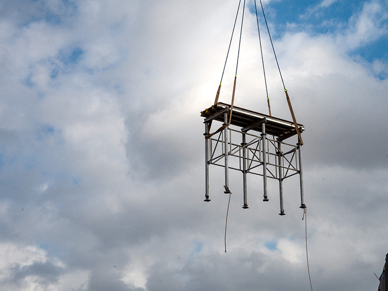 Crane setting forms to construct second floor