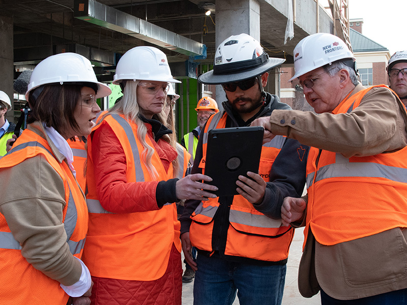 Looking at floor plans on construction site