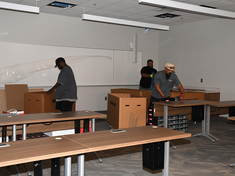 Movers unpacking computer equipment