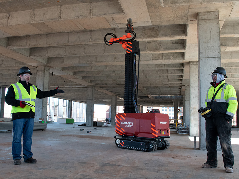 Construction workers show jaibot robot to OSU students