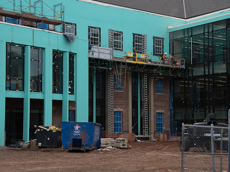 Installing brick on front of building