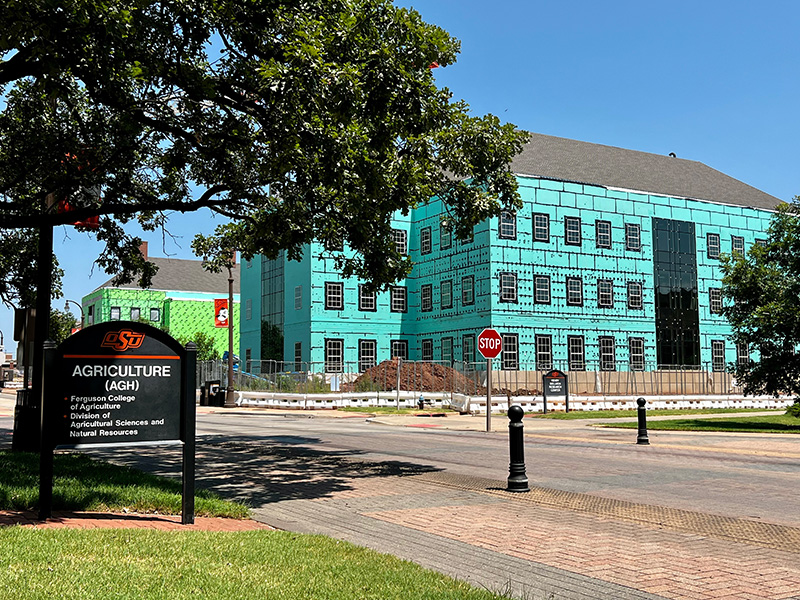 Ag Hall sign with New Frontiers building in the background