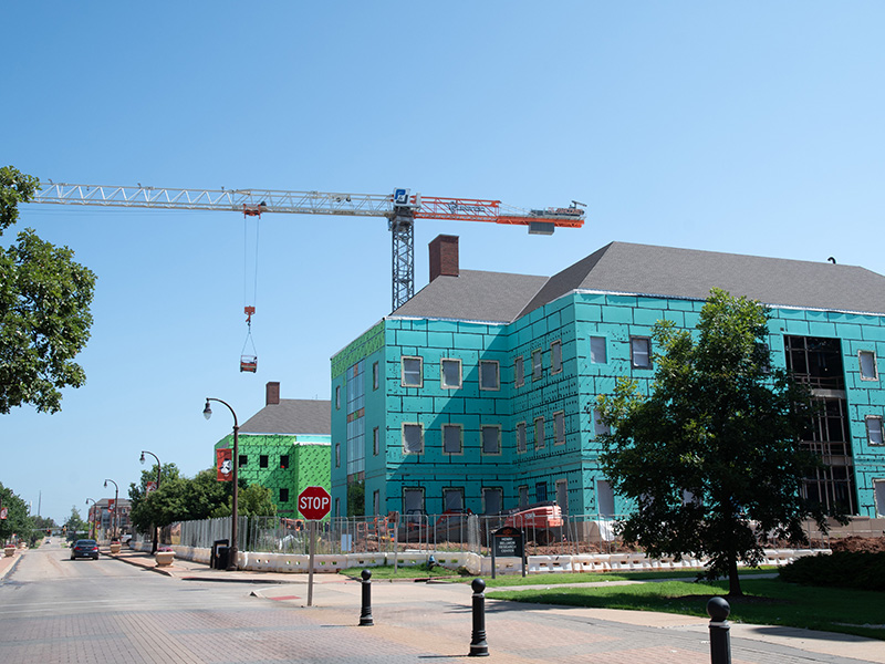 Crane moving material on construction site