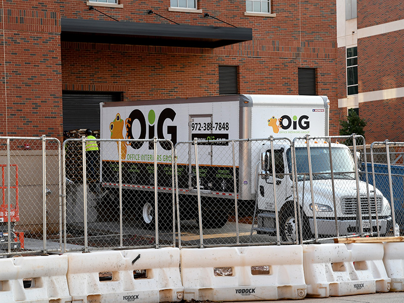 Truck backed up to the dock on the south side of the building