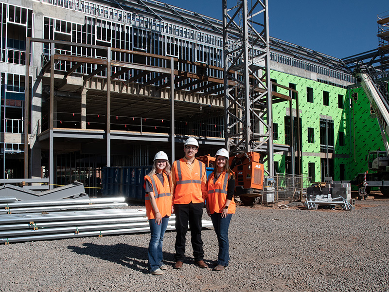 Students in front of New Frontiers construction