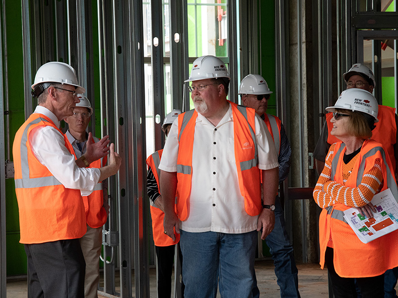 Dr. Coon talking with tour participants