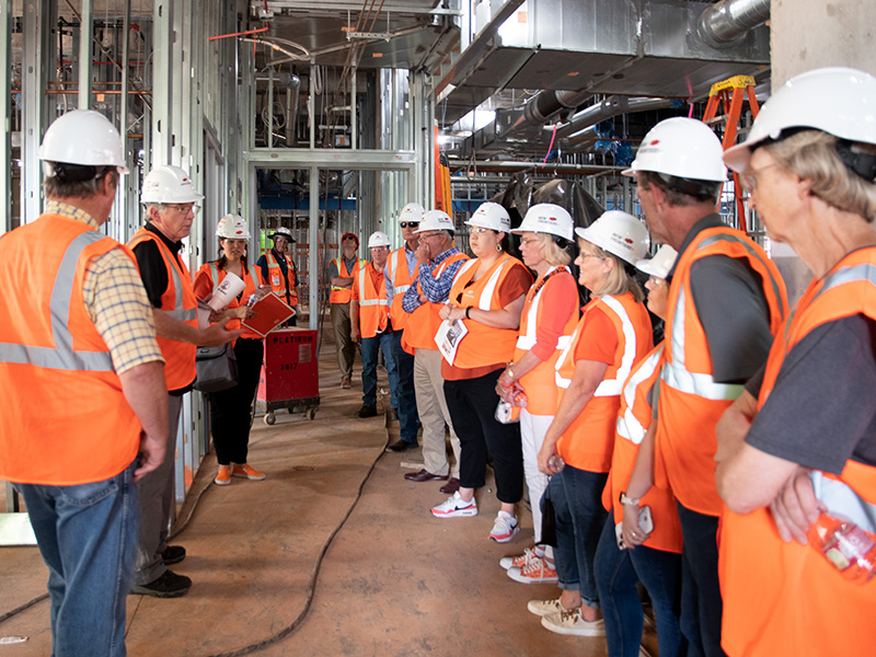 Participants gather around tour guide