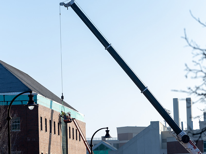 wide shot of installing stone on New Frontiers building