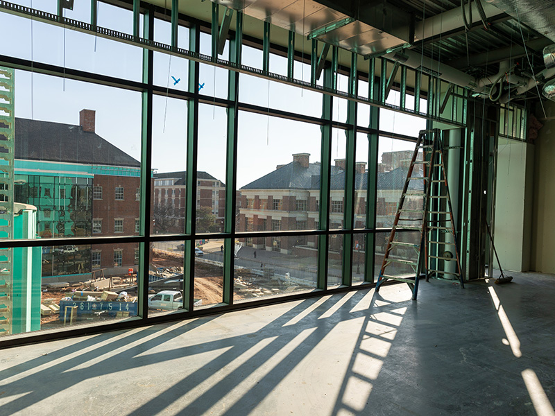Looking outside from interior space in New Frontiers Agricultural Hall